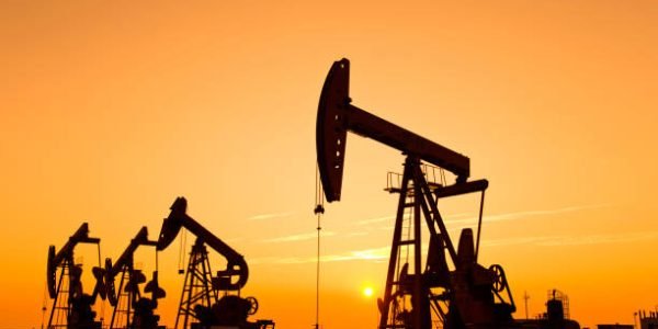 Oil pumps and rig at sunset Oil pumps and rig at sunset