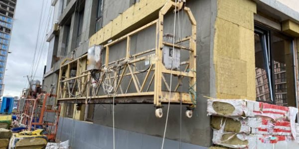 Jinshuo HEMC for external insulation systems Construction workers insulating house facade. External wall insulation system or EWIS mineral wool for energy saving.